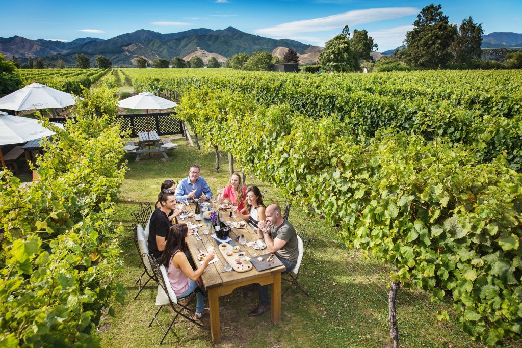 A group of people gathered a around a table at Saint Clair Family Estate Winery.